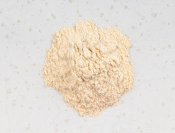 top view of pile of apple pectin powder close up on gray ceramic plate