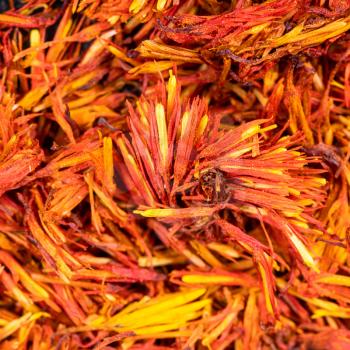 square food background - dried safflower blooms close up