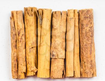 top view of several sticks of continental ceylon cinnamon close up on gray ceramic plate