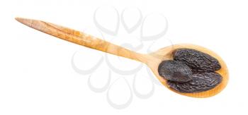 top view of dried tonka beans in wood spoon isolated on white background