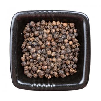 top view of hainan black pepper in black bowl isolated on white backgrouns