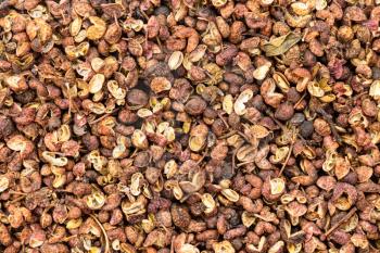 food background - many dried pink sichuan peppercorns