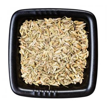 top view of fennel seeds in black bowl isolated on white background