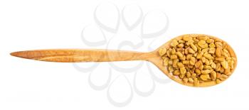 top view of wood spoon with fenugreek seeds isolated on white background