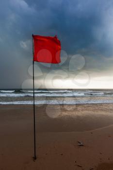 Severe storm warning flags on beach. Baga, Goa, India
