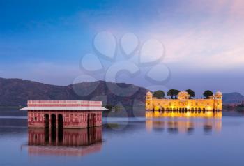 Rajasthan landmark - Jal Mahal Water Palace on Man Sagar Lake in the evening in twilight.  Jaipur, Rajasthan, India