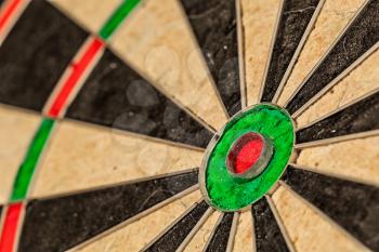 Success hitting target aim goal achievement concept background - bull's eye of darts board close up