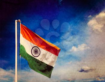 Vintage retro effect filtered hipster style image of India indian flag against blue sky with copyspace