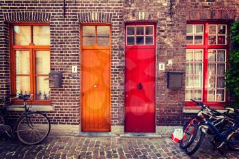 Doors of old houses and bicycles in european city. Bruges Brugge, Belgium