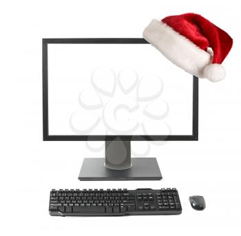 Cristmas online shopping concept - Computer workstation (monitor, keyboard, mouse) monitor with Santa hat   isolated on white background