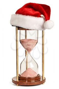 Christmas is coming concept - hourglass  with Santa Claus hat isolated on white background