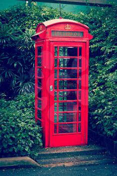 Vintage retro effect filtered hipster style travel image of red English telephone booth