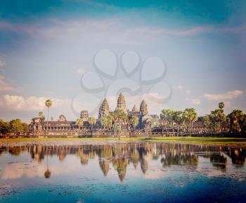 Vintage retro effect filtered hipster style image of Cambodia landmark Angkor Wat with reflection in water