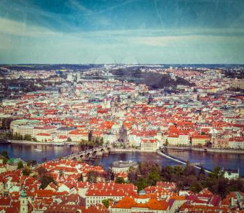 Vintage retro hipster style travel image of aerial view of Charles Bridge over Vltava river and Old city from Petrin hill Observation Tower with grunge texture overlaid. Prague, Czech Republic