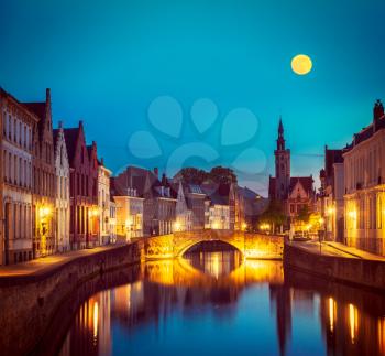 Vintage retro hipster style travel image of European medieval night city view background - Bruges Brugge canal in the evening, Belgium