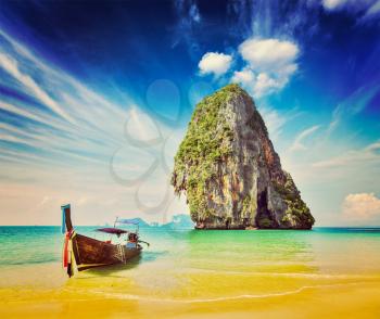 Retro vintage hipster style image of tropical vacation holiday beach concept - Long tail boat on tropical beach, Krabi, Thailand
