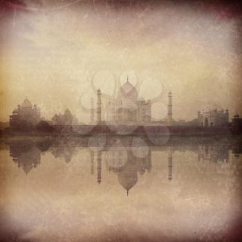 Vintage retro hipster style image of Taj Mahal on sunrise sunset reflection in Yamuna river panorama in fog, Indian Symbol - India travel background with grunge texture overlaid. Agra, Uttar Pradesh, 