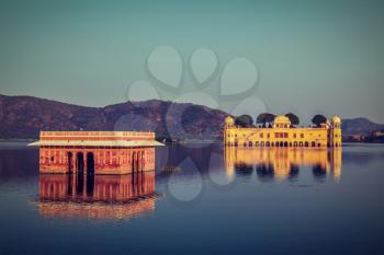 Vintage retro hipster style travel image of Rajasthan landmark - Jal Mahal (Water Palace) on Man Sagar Lake on sunset.  Jaipur, Rajasthan, India