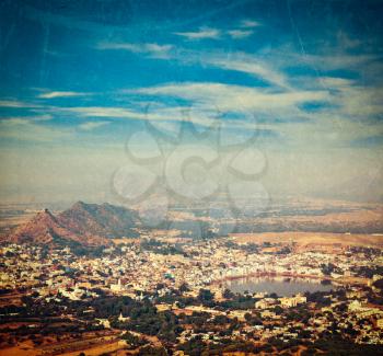 Vintage retro hipster style travel image of Holy city Pushkar aerial view from Savitri temple with grunge texture overlaid. Rajasthan, India