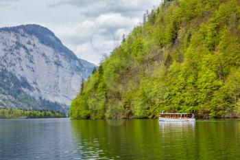 Tourist boat at alpine mountain lake Konigssee, Bavaria, Germany