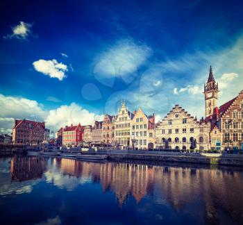 Vintage retro hipster style travel image of Europe Belgium medieval town travel background - Ghent canal and Graslei street on sunset. Ghent, Belgium