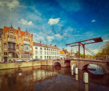 Vintage retro hipster style travel image of canal with old bridge. Bruges (Brugge), Belgium with grunge texture overlaid