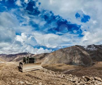 Bulldozer on road in Himalayas. Ladakh, Jammu and Kashmir, India