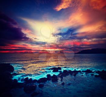 Vintage retro hipster style travel image of ocean sunset with great cloudscape