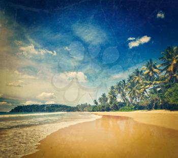 Vintage retro hipster style travel image of tropical vacation holiday background - paradise idyllic beach with grunge texture overlaid. Sri Lanka
