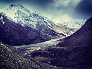 Vintage retro effect filtered hipster style travel image of severe mountains - Spiti valley, river, road in Himalayas. Himachal Pradesh, India