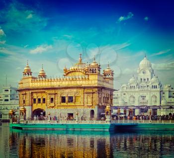 Vintage retro hipster style travel image of famous India attraction Sikh gurdwara Golden Temple (Harmandir Sahib). Amritsar, Punjab, India