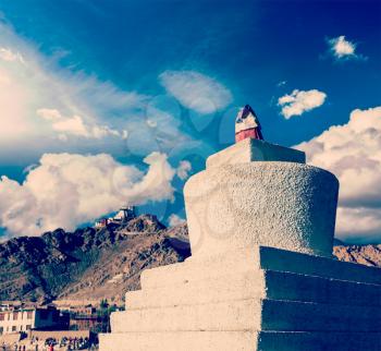 Vintage retro effect filtered hipster style travel image of Whitewashed chorten and Tsemo fort and gompa. Leh, Ladakh, India