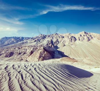 Vintage retro effect filtered hipster style travel image of Sand dunes in Himalayas. Hunder, Nubra valley, Ladakh, India