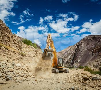 Excavator doing road construction in Himalayas. Ladakh, Jammu and Kashmir, India