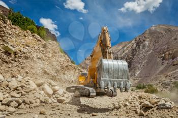 Excavator doing road construction in Himalayas. Ladakh, Jammu and Kashmir, India
