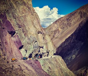 Vintage retro effect filtered hipster style travel image of Road construction in Himalayas. Ladakh, Jammu and Kashmir, India