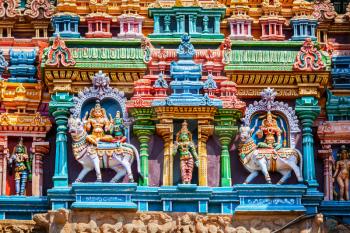Shiva and Parvati on bull images. Sculptures on Hindu temple gopura tower. Minakshi Temple, Madurai, Tamil Nadu, India