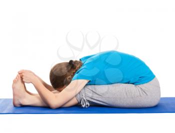 Yoga - young beautiful slender woman yoga instructor doing Seated Forward Bend or Intense Dorsal Stretch pose asana (Paschimottanasana) exercise isolated on white background