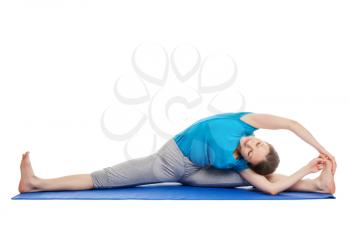 Yoga - young beautiful slender woman yoga instructor doing Revolved Wide Seated Forward Bend Pose (parivrtta upavistha konasana) asana exercise isolated on white background