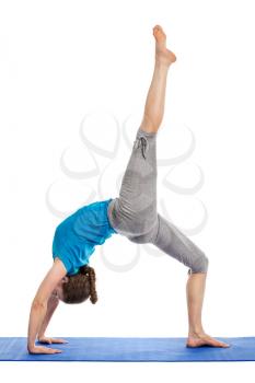 Yoga - young beautiful slender woman yoga instructor doing One-legged Upward Bow Pose (ekapada urdhva dhanurasana) asana exercise isolated on white background