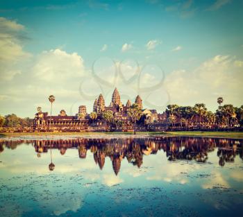 Vintage retro effect filtered hipster style travel image of Cambodia landmark Angkor Wat with reflection in water