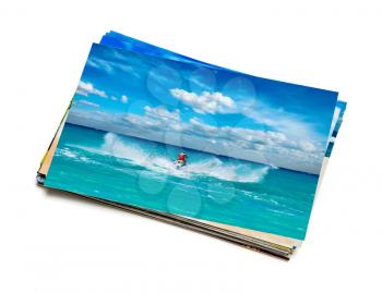 Holidays beach adventure concept creative background - stack of vacation photos with man riding jet ski image on top isolated on white background
