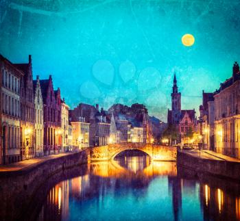 Vintage retro hipster style travel image of European medieval night city view background - Bruges (Brugge) canal in the evening, Belgium