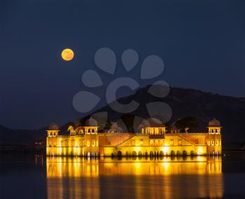 Rajasthan landmark - Jal Mahal (Water Palace) on Man Sagar Lake at night in twilight.  Jaipur, Rajasthan, India