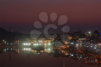 Sacred Puskhar lake (Sagar) and ghats of  town Pushkar in twilight in the evening, Rajasthan, India