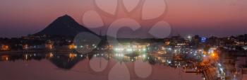Panorama of Sacred Puskhar lake (Sagar) and ghats of  town Pushkar in twilight in the evening, Rajasthan, India