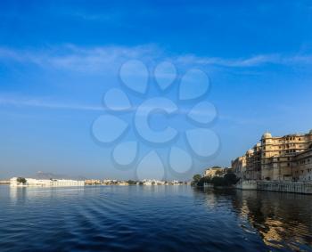 Romantic India luxury tourism concept background - Udaipur City Palace, Lake Palace and Lake Pichola. Udaipur, Rajasthan, India