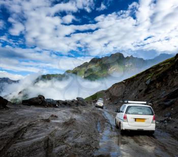 Vehicles on bad road in Himalayas. Near Rohtang La pass, Himachal Pradesh, India