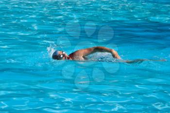 Athletic Man swimming in the pool