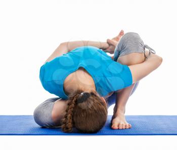 Yoga - young beautiful slender woman yoga instructor doing Forward Bends Sage Twist B pose (Marichyasana B) asana exercise isolated on white background